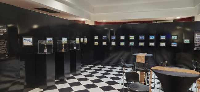 exhibition display black walls checkered floor